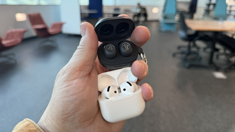 Man holding AirPods with ANC and JBuds Mini