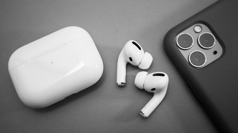 AirPods and case with iPhone