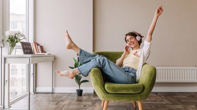 woman smiling at home in headphones