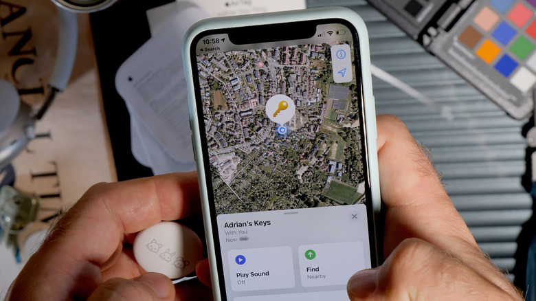 person using AirTag to locate keys