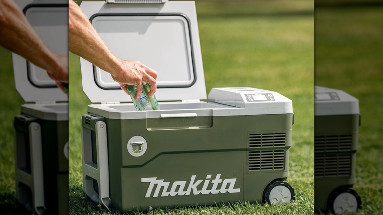 Person grabbing drink from Makita Outdoor Adventure Smart Cooler