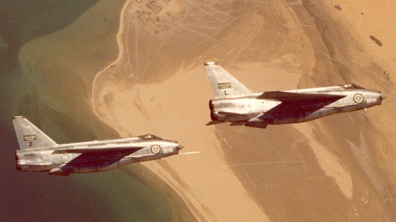 Two English Electric Lightnings flying in close formation over a desert