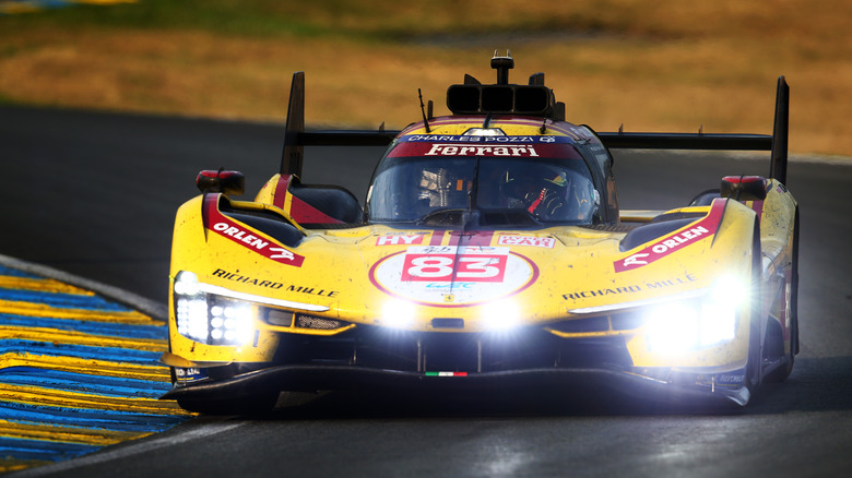 Le Mans-winning Ferrari 499P on track in yellow, front view