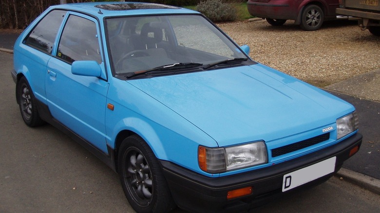 Parked blue Mazda 323 GTX