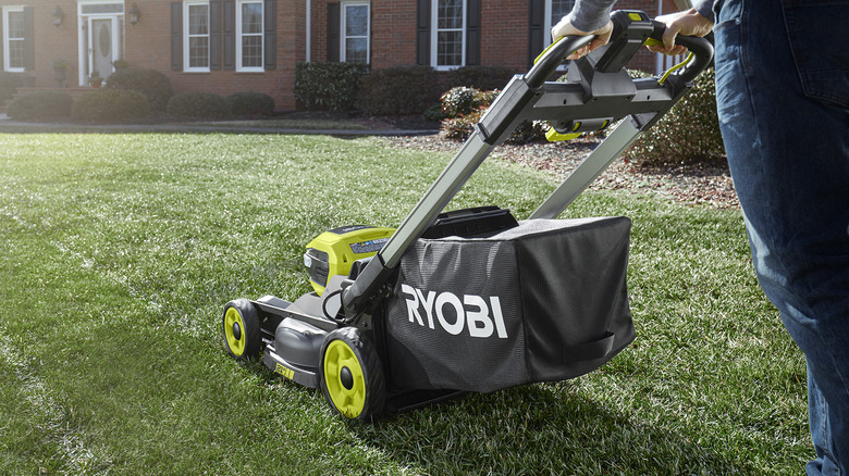 Person using a Ryobi lawnmower