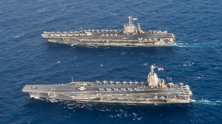 The USS Gerald R. Ford beside the USS Harry S. Truman at sea