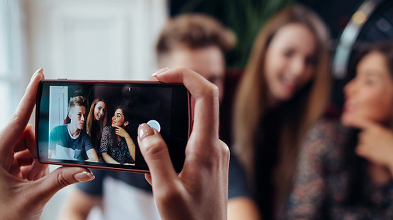 person with smartphone taking picture