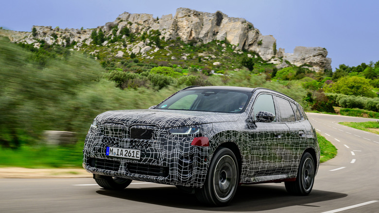 Front 3/4 view of camouflaged BMW X3