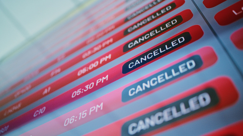 Artwork depicting a departure board in an airport with multiple cancelled flights.