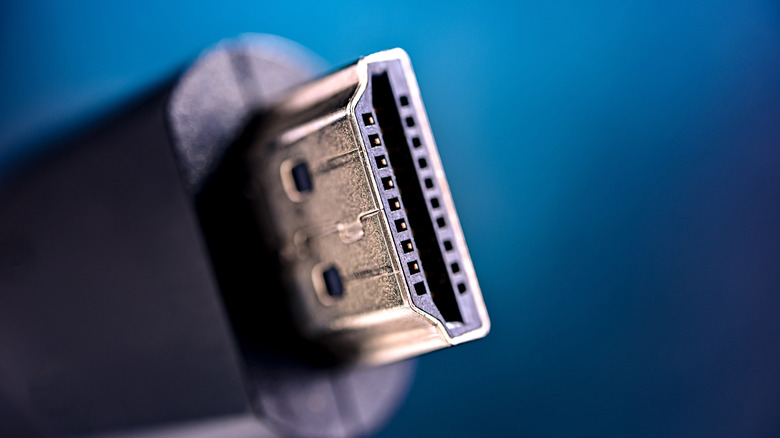 A close-up of the connector on an HDMI cable against a blue background