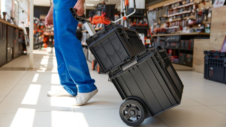 A person pulling a rolling tool box