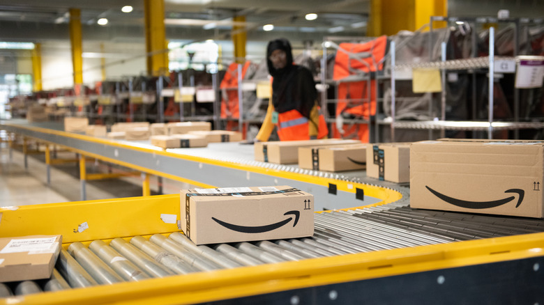 Amazon employee works conveyor belt