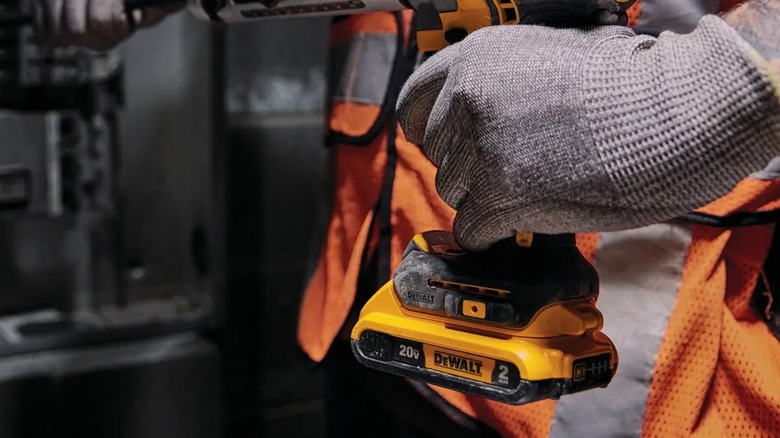 DeWalt 2.0 Ah 20V Max battery attached to a power tool in use.