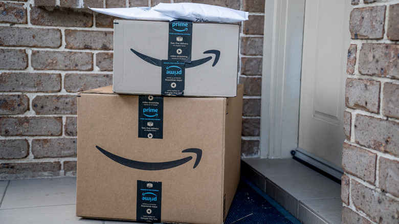 Amazon boxes stacked up in front of a door