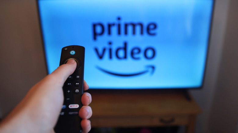 A person uses a Fire Stick remote to watch Amazon Prime Video