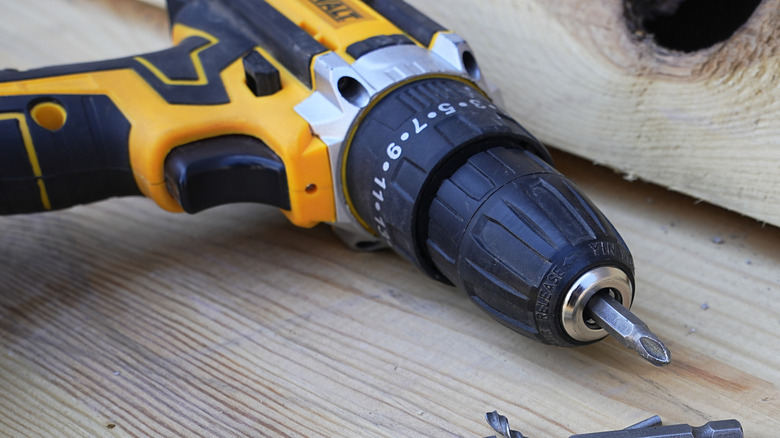 Dewalt drill laying on its side on a wood surface