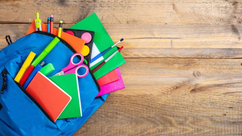 Child's blue backpack filled with school supplied