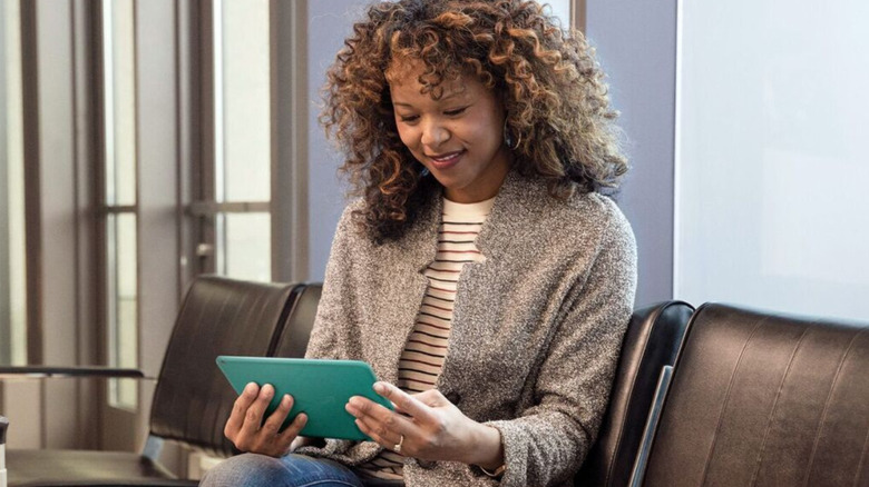 A woman holding the Amazon Fire HD 8 tablet