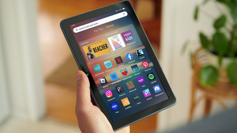 The Amazon Fire HD 8 tablet in hand showing home screen