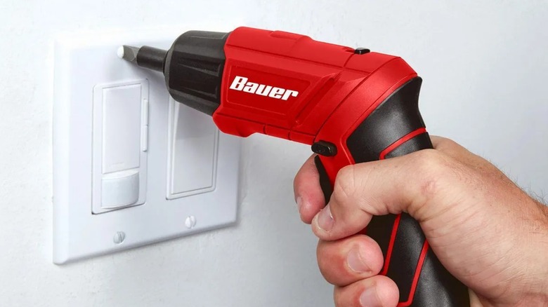 a person using a bauer cordless 4-volt screwdriver
