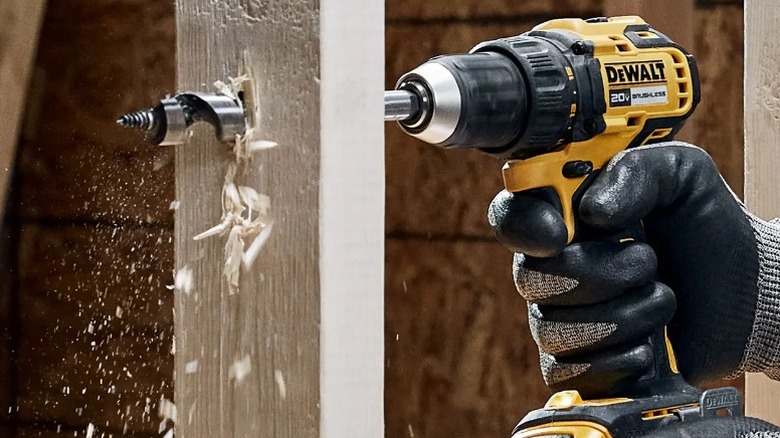 Person drilling hole with a DeWalt 20V Max ½-inch Drill