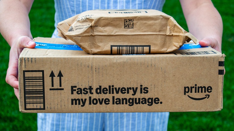 A woman holds Amazon Prime packages