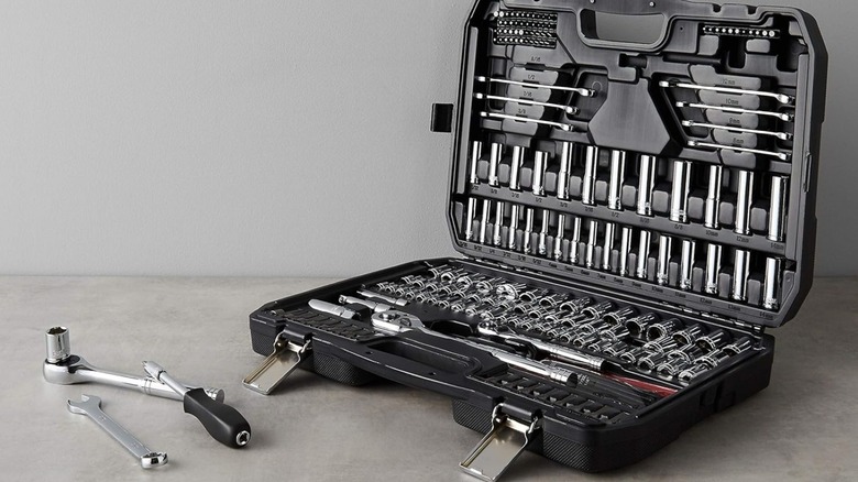 An Amazon Basics socket set containing various size wrenches, sockets, and ratchets in a closable case.