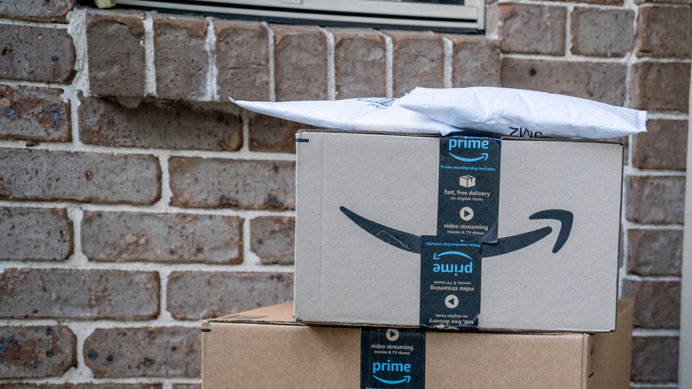 Amazon delivery boxes in front of a door.