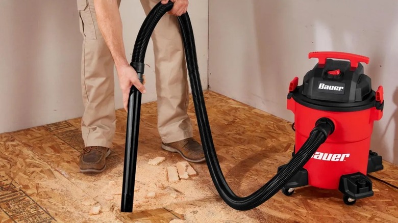 A person using a Harbor Freight bauer 6-gallon shop vac