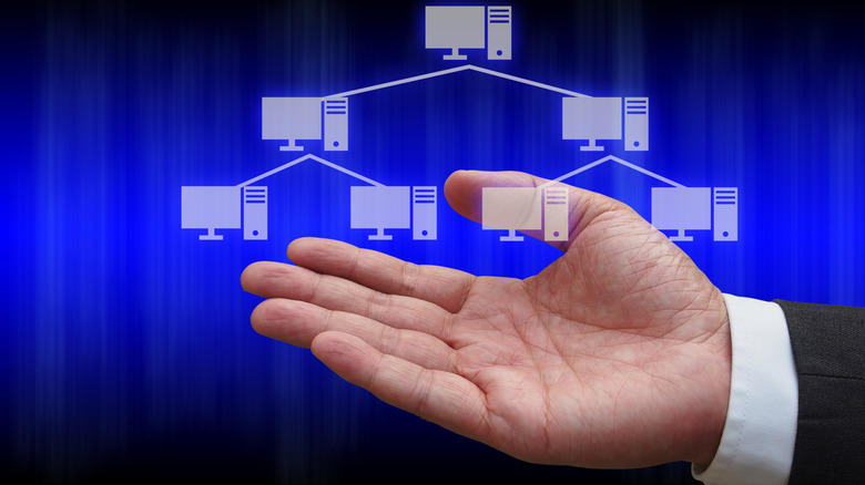 An illustration of a hand holding a design of a tree topology network design