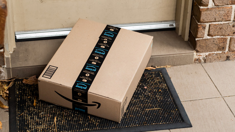 An Amazon box in fornt of a door.