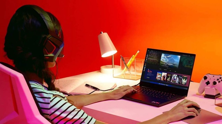 Woman playing games on-powered laptop