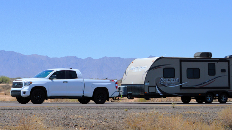 Toyota pickup truck towing a large travel trailer