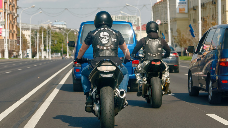 Two bikers from the Minsk-based club, The Hooligans riding down a road