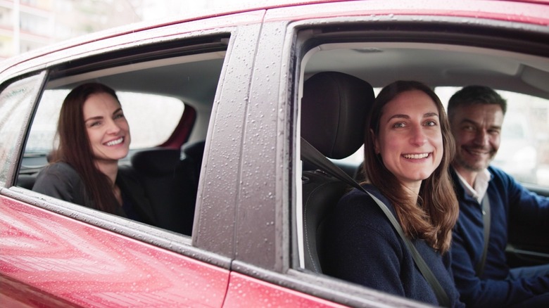 People smiling as they carpool to work