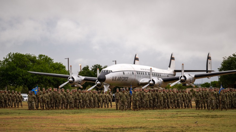 U.S. Air Force basic training class in parade formation around an aircraft.