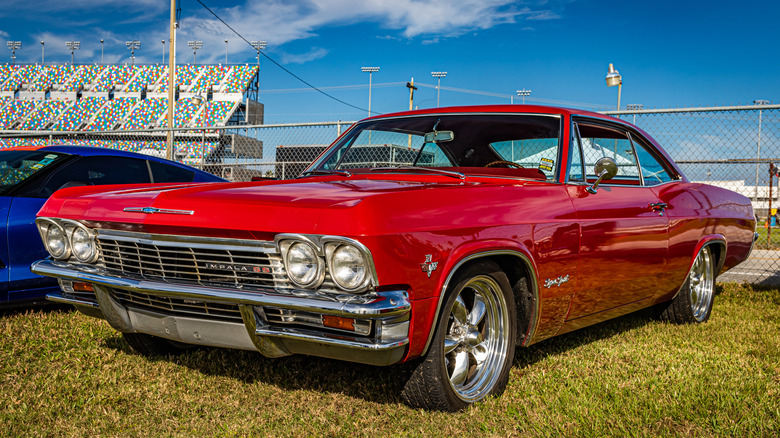 Front 3/4 view of 1965 Chevrolet Impala in car show setting