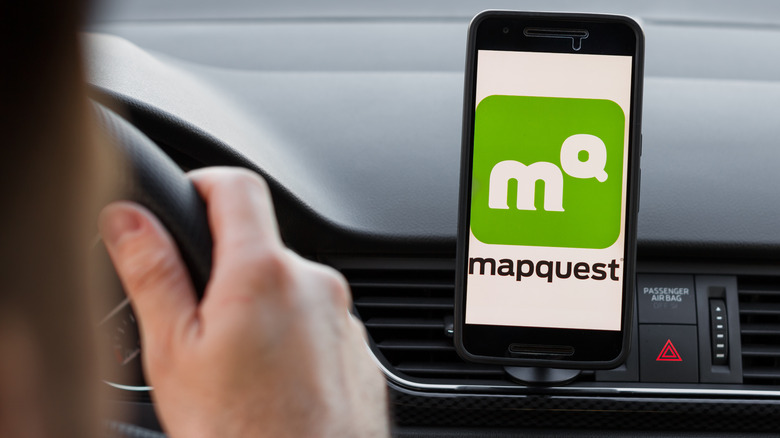A photo of MapQuest homepage on a monitor screen through a magnifying glass
