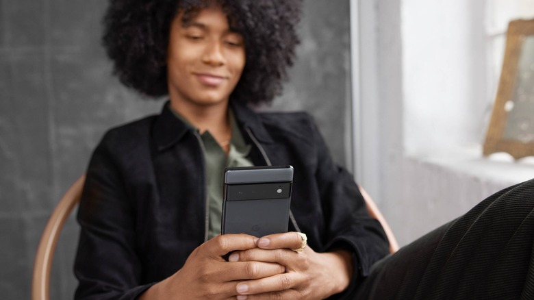 Woman holding Google Pixel 6