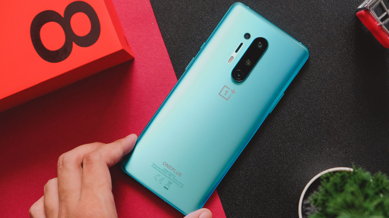 A OnePlus 8 Pro in the blue colorway kept on a table next to its box