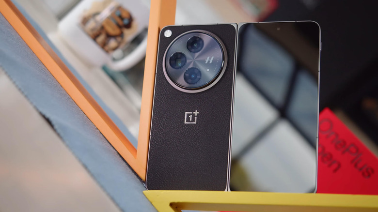 A OnePlus Open folding phone with its box in the background