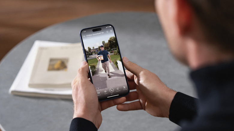 Person viewing live doorbell camera footage on their smartphone
