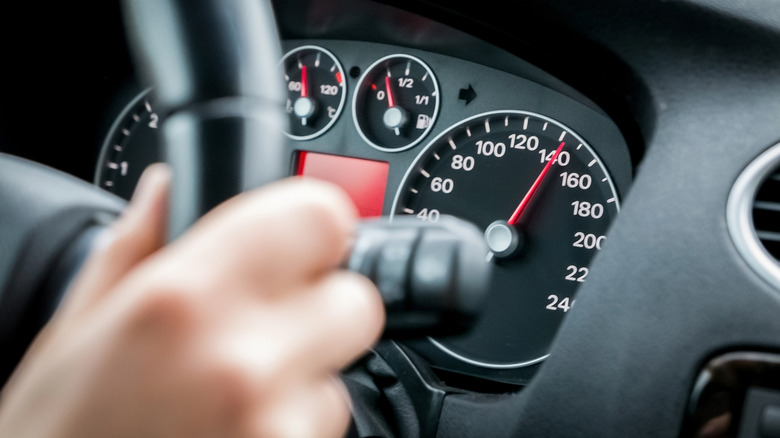A car speedometer showing an increase in speed.