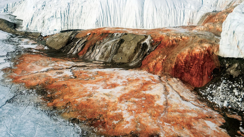 red water exiting glacier