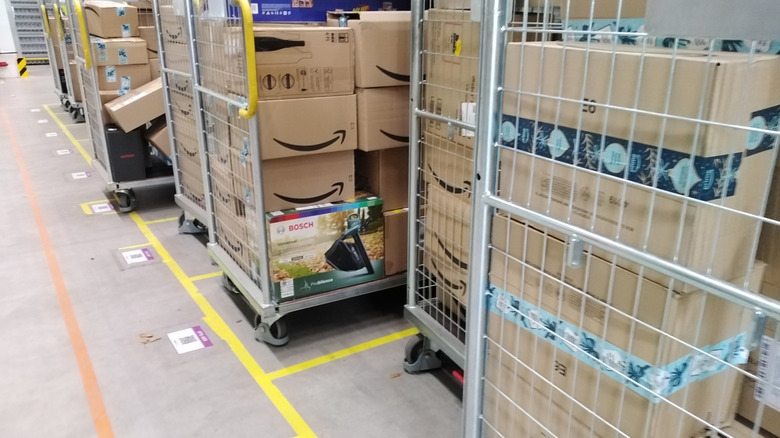 Stacks of Amazon packages in rolling metal carts