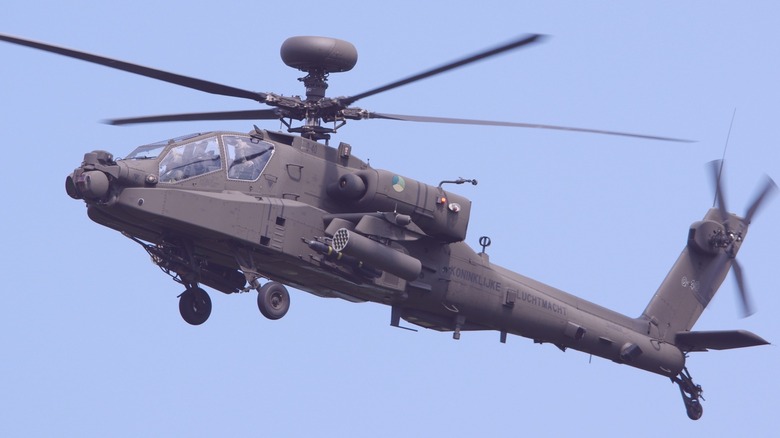An AH-64 Apache in flight over blue skies
