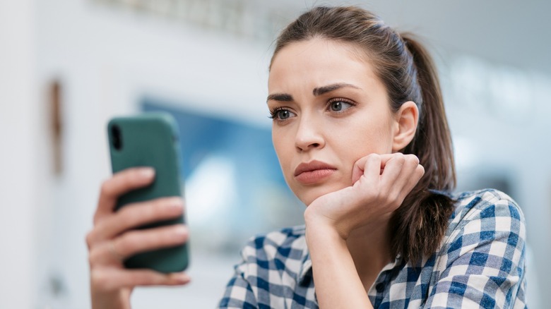 woman looking at her phone