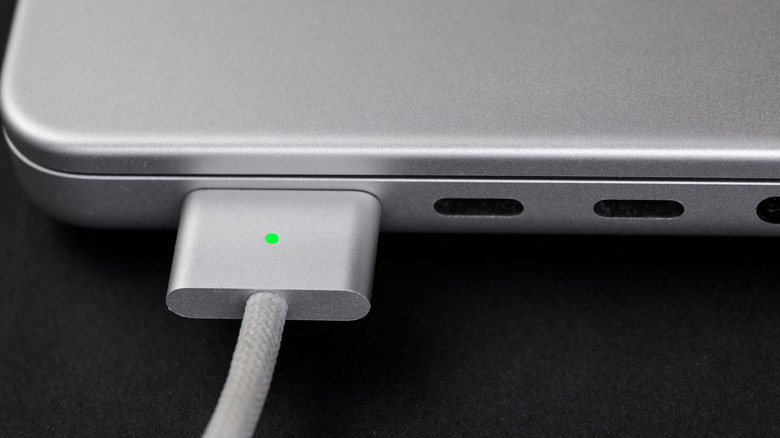 A braided MagSafe 3 connector plugged into a MacBook