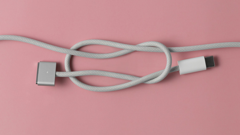 A braided MagSafe 3 to USB-C cable tied in a knot
