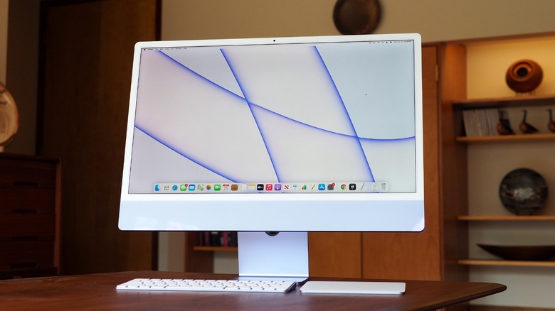 A series of iMacs arranged in a fan shape over a white background